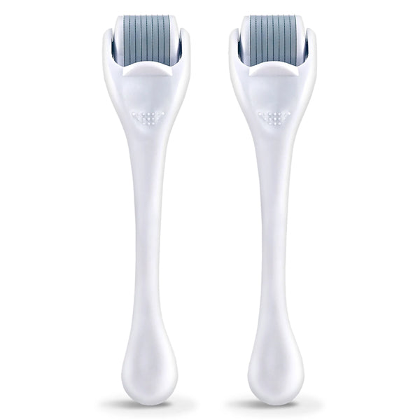 The 2 Pack - Plum Beauty Facial Microneedling Facial Roller and Massager in White by Plum features two cylindrical rollers with fine needles—ideal for boosting collagen and revealing smoother, more youthful-looking skin.